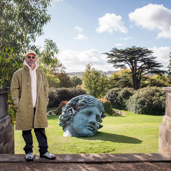 Daniel Arsham beside Unearthed Bronze Eroded Melpomene in the garden at Yorkshire Sculpture Park.