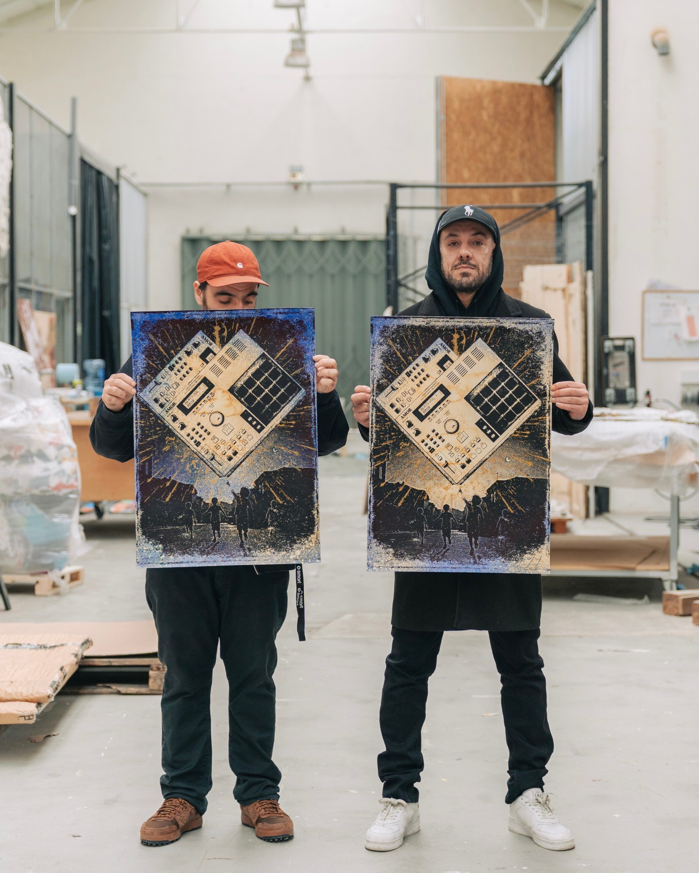 Official photograph of two examples of Beats Vol.1: Amor, Gold held by the artists; tonal variation is not a separately named edition.