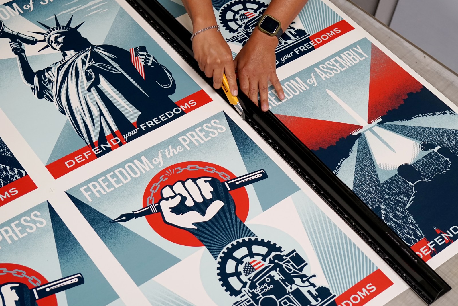 Official photograph of Monster Media community-poster production, showing Freedom of Speech at upper left alongside the other campaign subjects. This is not the numbered screenprint edition.