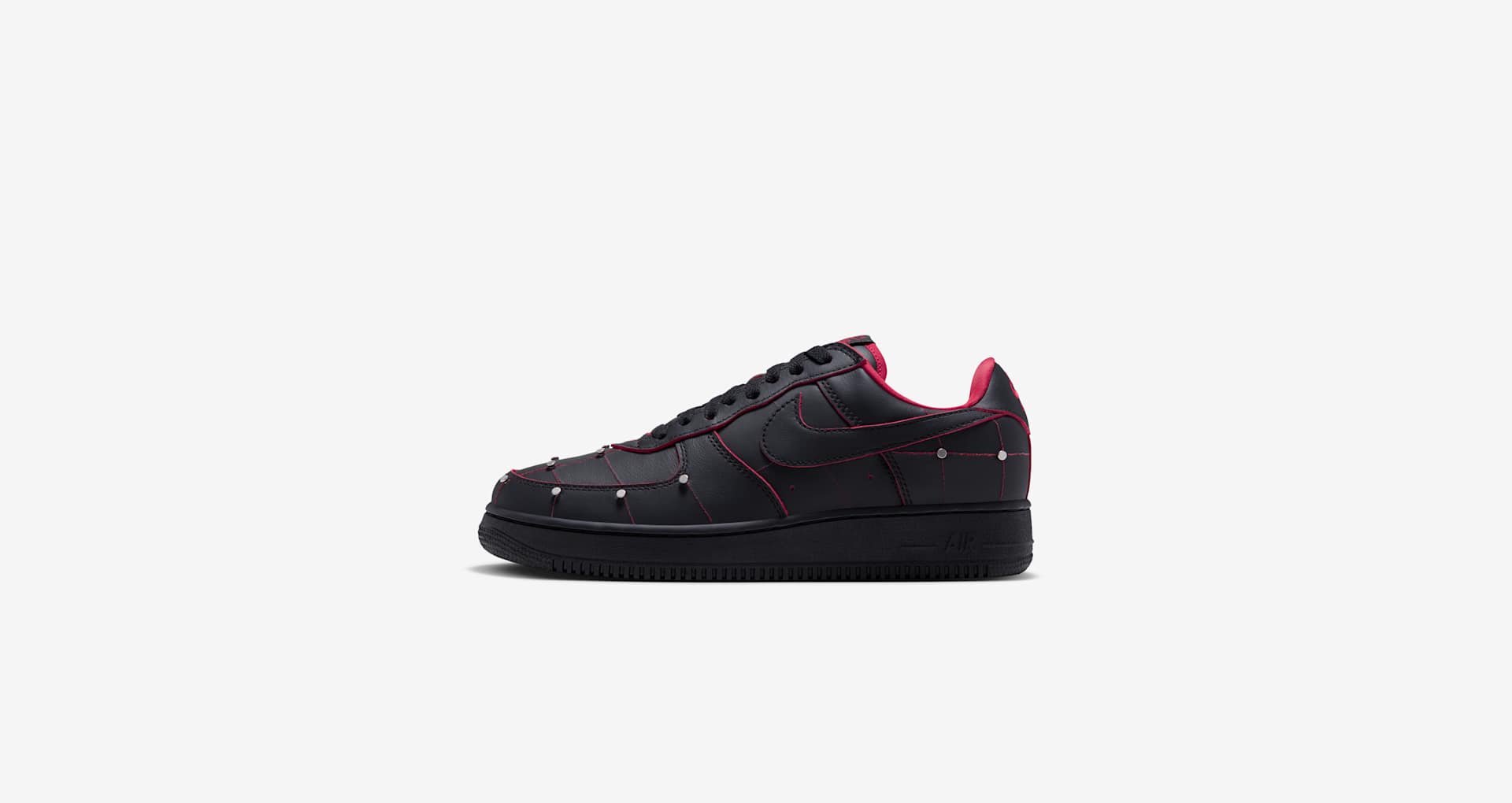 Nike Air Force 1 ’01 Nightmare IX0104-001 in Black and Gym Red, with metallic pins and red seams across a black leather upper and black sole.